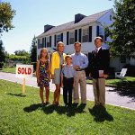 Happy family with REALTOR and home sold